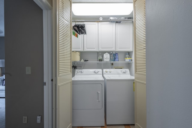 washroom featuring cabinets and independent washer and dryer