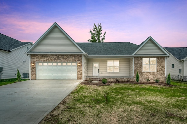 ranch-style house featuring a lawn and a garage