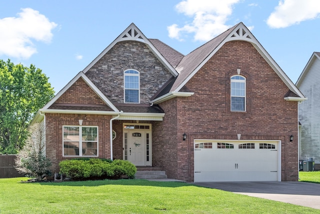 view of front of house featuring central AC unit, a garage, and a front lawn