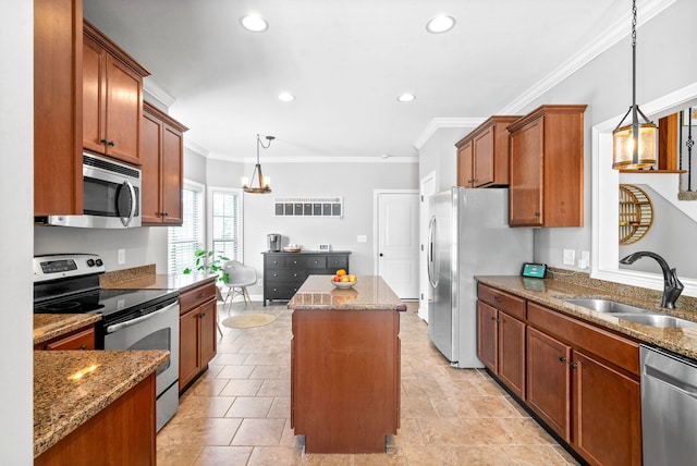 kitchen with crown molding, a kitchen island, decorative light fixtures, sink, and appliances with stainless steel finishes