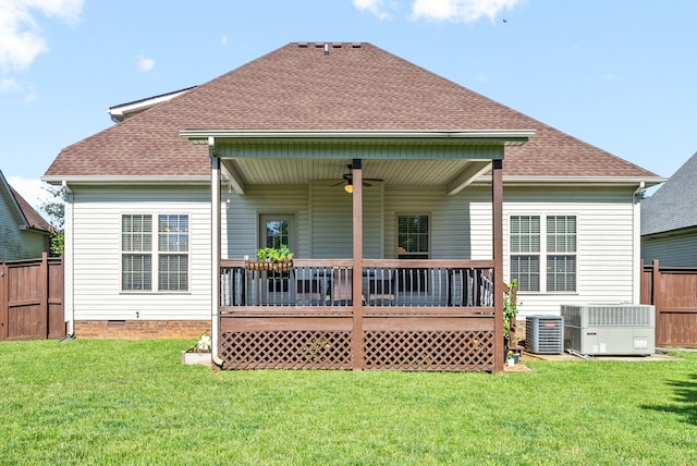 back of property with a yard, a wooden deck, central AC, and ceiling fan