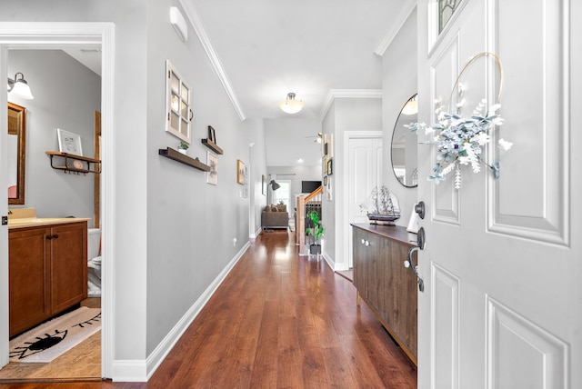 foyer with ornamental molding and hardwood / wood-style floors