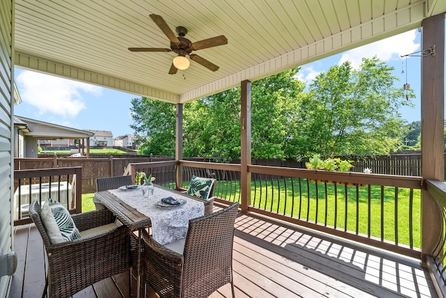 wooden deck featuring ceiling fan and a yard