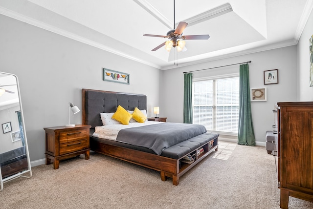 bedroom featuring ceiling fan, light colored carpet, a raised ceiling, and ornamental molding