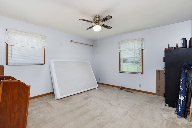 bedroom with ceiling fan and light carpet