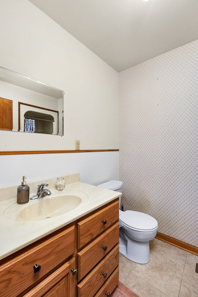 bathroom featuring tile patterned floors, vanity, and toilet