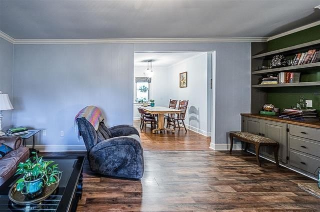 sitting room with crown molding and dark hardwood / wood-style floors