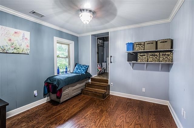 bedroom featuring ornamental molding and dark wood-type flooring