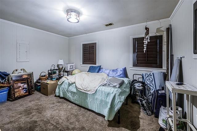 bedroom with electric panel, ornamental molding, and carpet flooring