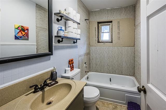 full bathroom featuring vanity, tile walls, toilet, and washtub / shower combination