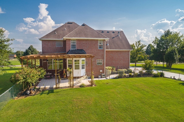 rear view of house with a patio, a yard, and a pergola