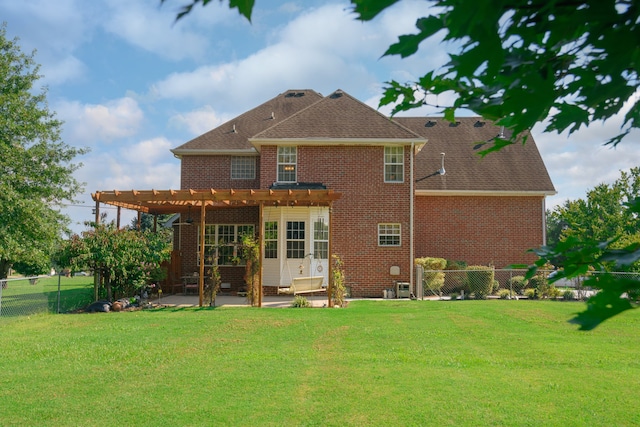 back of house featuring a pergola, a patio area, and a lawn