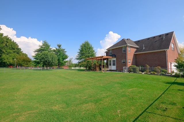 view of yard with central AC and a pergola