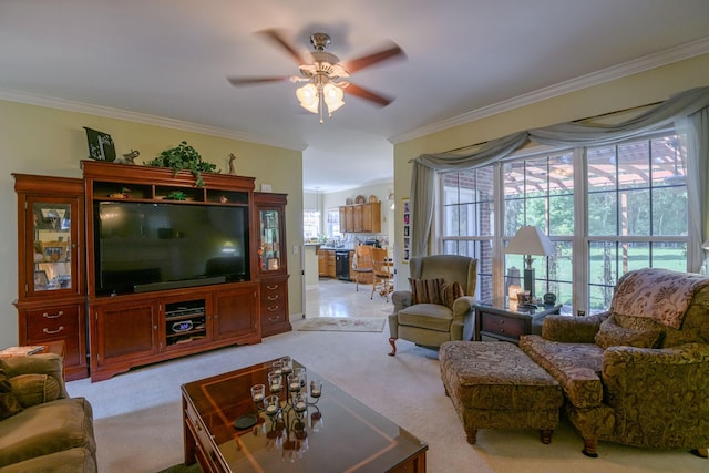 living room featuring light carpet, ornamental molding, and ceiling fan