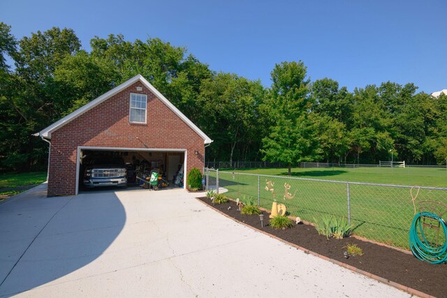 view of property's community featuring a yard and an outbuilding