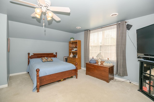 bedroom featuring ceiling fan, vaulted ceiling, and light carpet