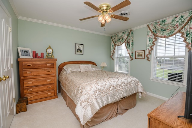 carpeted bedroom featuring crown molding and ceiling fan