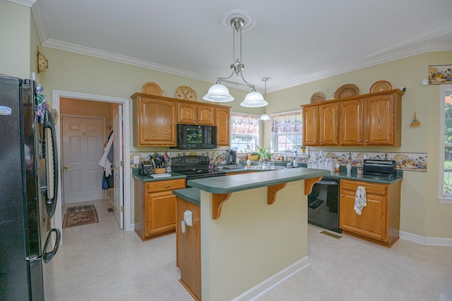 kitchen with a breakfast bar area, hanging light fixtures, ornamental molding, a kitchen island, and black appliances