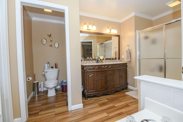 bathroom featuring crown molding, vanity, hardwood / wood-style flooring, and toilet