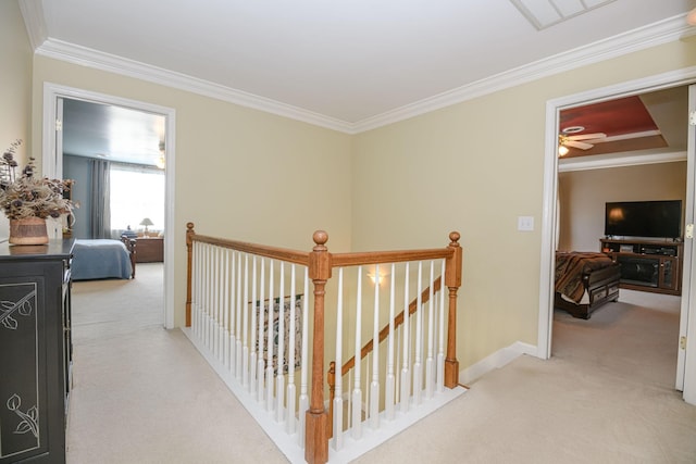 hall with ornamental molding and light carpet