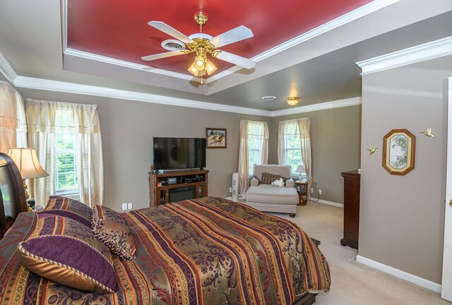 carpeted bedroom featuring crown molding, ceiling fan, and a tray ceiling