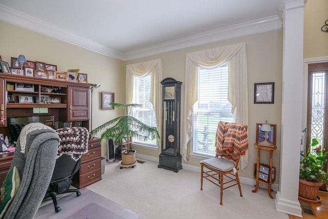 carpeted home office featuring a wealth of natural light, ornamental molding, and decorative columns