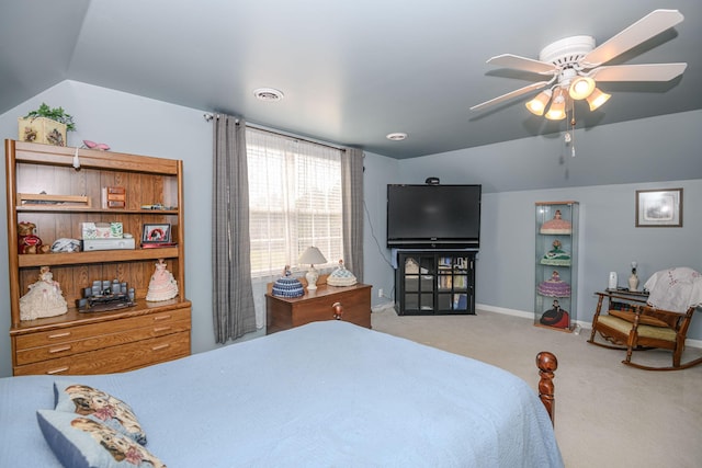 carpeted bedroom with ceiling fan and vaulted ceiling