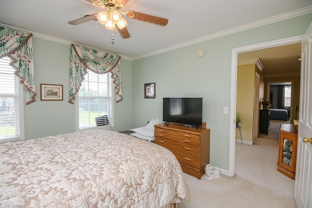 carpeted bedroom featuring ornamental molding and ceiling fan