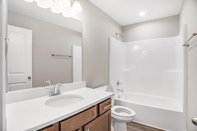 full bathroom with shower / tub combination, hardwood / wood-style floors, vanity, and toilet