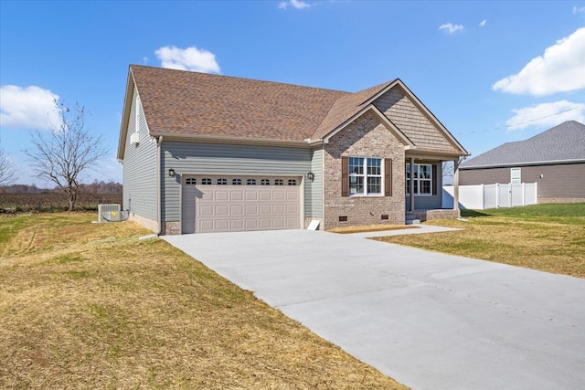 view of front of home with central air condition unit, a front lawn, and a garage