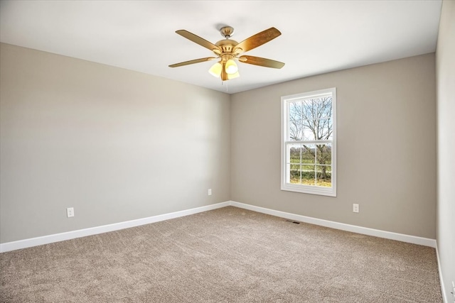 carpeted empty room featuring ceiling fan