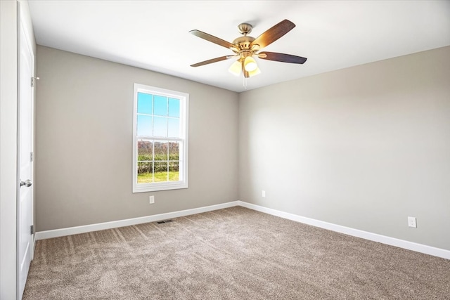 carpeted empty room featuring ceiling fan