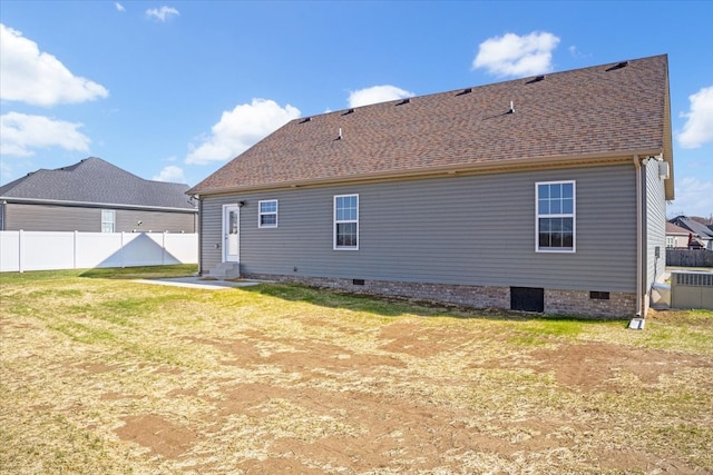 rear view of property with a lawn