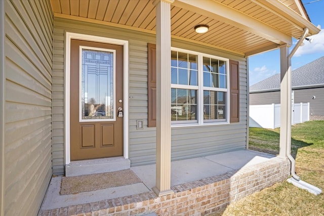 view of exterior entry with a porch