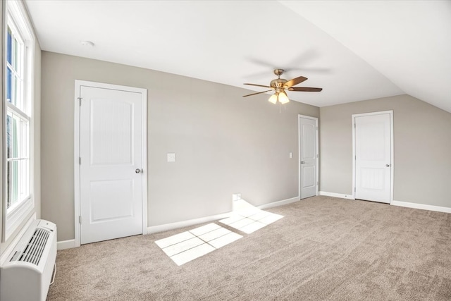 bonus room with ceiling fan, light colored carpet, a wall mounted AC, and vaulted ceiling