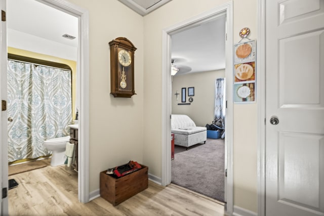 bathroom featuring hardwood / wood-style flooring and toilet