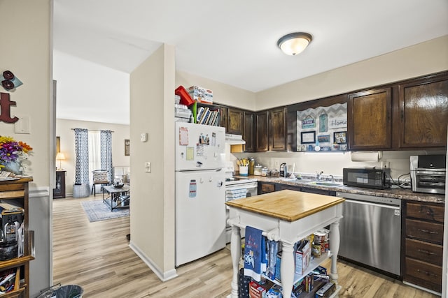 kitchen featuring white appliances, dark brown cabinetry, sink, and light wood-type flooring