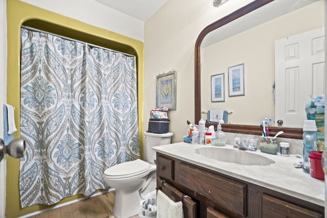 bathroom featuring wood-type flooring, vanity, toilet, and a shower with shower curtain