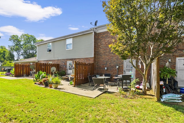 back of house with a patio and a yard