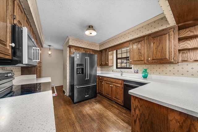 kitchen featuring a textured ceiling, stainless steel appliances, sink, and dark hardwood / wood-style flooring