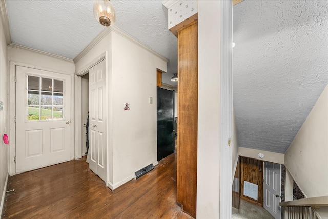 hallway featuring vaulted ceiling, dark hardwood / wood-style floors, a textured ceiling, and crown molding