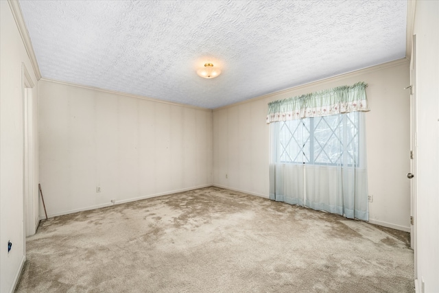 carpeted empty room featuring a textured ceiling and ornamental molding