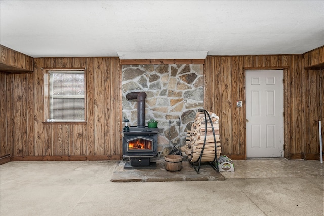 details with wooden walls and a wood stove