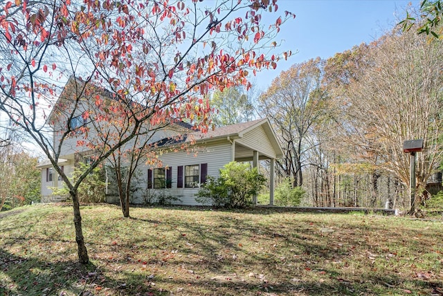 view of side of home with a lawn