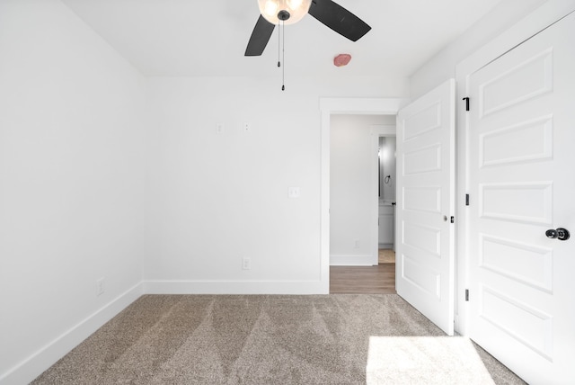 spare room featuring carpet floors and ceiling fan