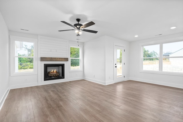 unfurnished living room featuring hardwood / wood-style floors and a healthy amount of sunlight