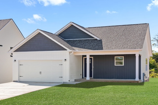 view of front of home with a garage and a front lawn