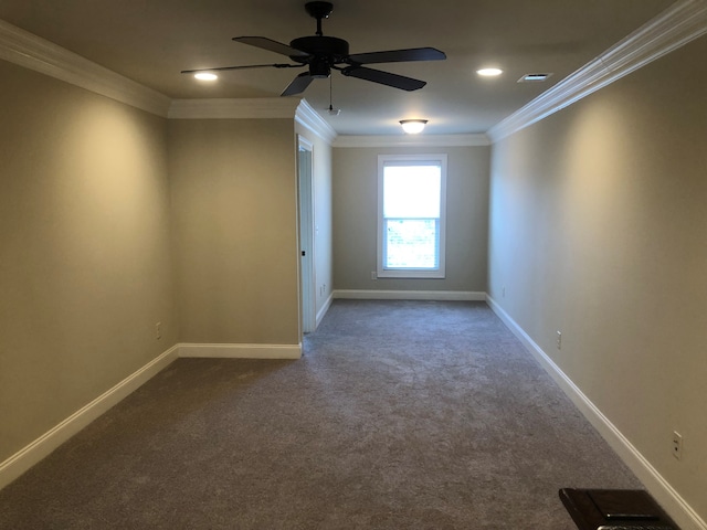 spare room featuring crown molding, ceiling fan, and carpet