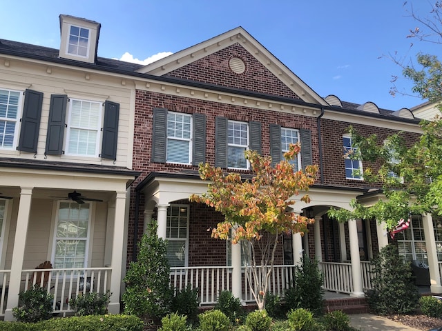 townhome / multi-family property with a porch