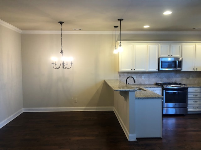 kitchen featuring white cabinets, sink, kitchen peninsula, appliances with stainless steel finishes, and decorative light fixtures